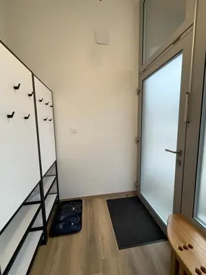 a room with a door with birds on the wall at ARIA apartment in Maribor