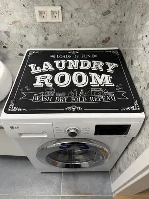 a sign for a laundry room on top of a machine at ARIA apartment in Maribor