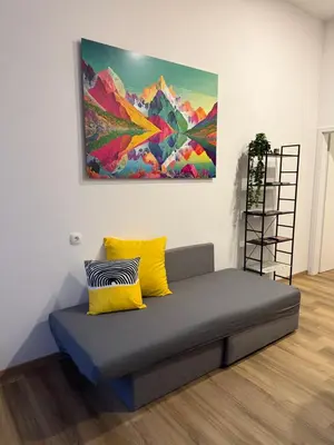 a couch in a room with a painting on the wall at ARIA apartment in Maribor