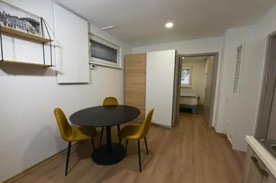 a dining room with a table and yellow chairs at Quiet One-Bedroom Near City Center Free Parking in Ljubljana