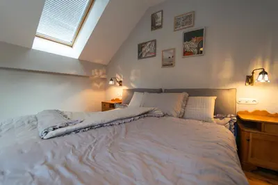 a bedroom with a large white bed with a window at Apartma Mauro in Kranjska Gora