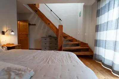 a bedroom with a bed and a staircase in a room at Apartma Mauro in Kranjska Gora