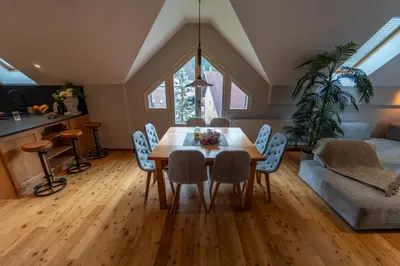 a kitchen and living room with a table and chairs at Apartma Mauro in Kranjska Gora