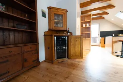 a kitchen with wooden cabinets and a fireplace at Apartma Mauro in Kranjska Gora