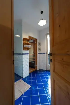 a hallway with a blue tile floor and a door at Apartma Mauro in Kranjska Gora