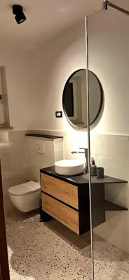 a bathroom with a sink and a mirror at River2Mountain Cozy Apartment in Gozd Martuljek