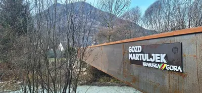 a sign on the side of a bridge at River2Mountain Cozy Apartment in Gozd Martuljek