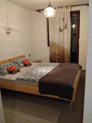 a bedroom with a bed and a shower at Planinski dom Kal in Dol pri Hrastniku