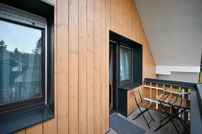 a balcony with a bench and a window at Green View Kamnik in Kamnik