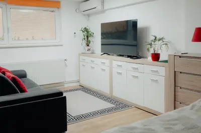 a living room with a couch and a flat screen tv at Apartment Berglez in Škofja Loka