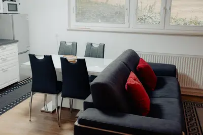 a living room with a couch and a table with chairs at Apartment Berglez in Škofja Loka