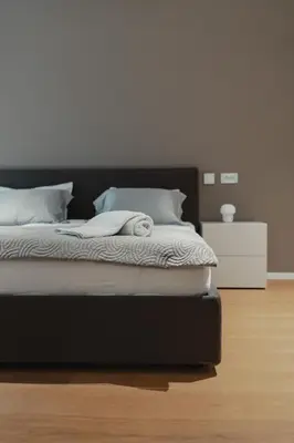 a bedroom with a bed with a black headboard at City Residence in Ljubljana