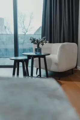 a living room with a couch and a table with flowers on it at City Residence in Ljubljana