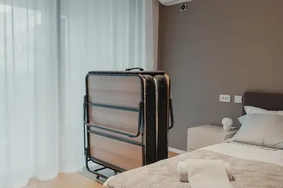 a suitcase sitting next to a bed in a room at City Residence in Ljubljana
