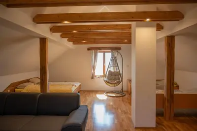 a living room with a couch and a bed at Vineyard cottage Mehak in Telče
