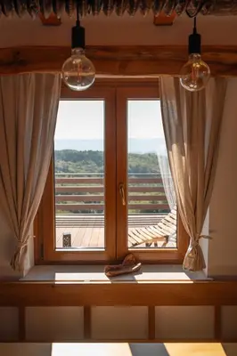 a window with curtains and a view of a deck at Vineyard cottage Mehak in Telče
