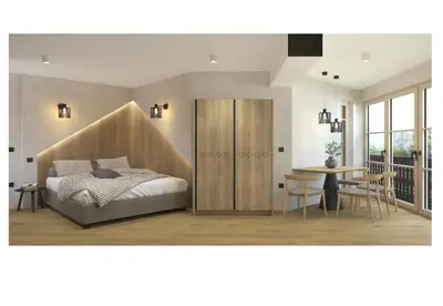 a bedroom with a bed and a table and chairs at Golf Apartments in Kranjska Gora
