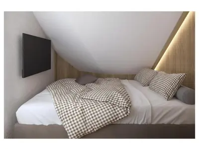 a bedroom with a bed with a tv on the wall at Golf Apartments in Kranjska Gora