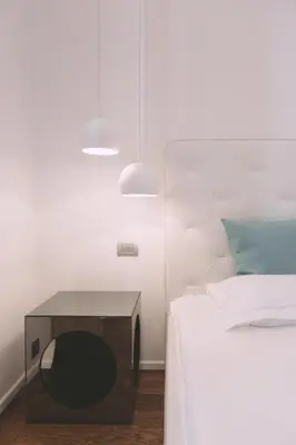 a bedroom with a bed and a table next to a bed at Ambassador Suite Studio in Ljubljana
