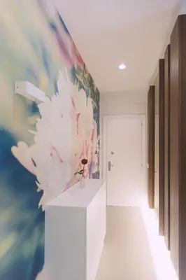 a hallway with a flower painting on the wall at Ambassador Suite Studio in Ljubljana