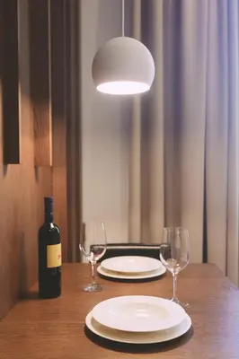 a table with two glasses and a bottle of wine at Ambassador Suite Studio in Ljubljana