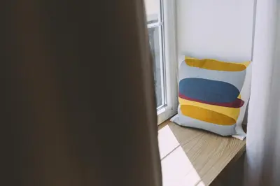 a pillow sitting in front of a window at Dragon's Den in Ljubljana