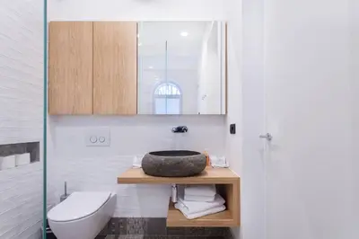 a bathroom with a sink and a toilet at Tivoli Double in Ljubljana
