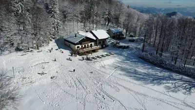 an aerial view of a ski lodge in the snow at Planinski dom Kal in Dol pri Hrastniku