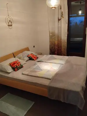 a bed with two pillows on top of it at Planinski dom Kal in Dol pri Hrastniku