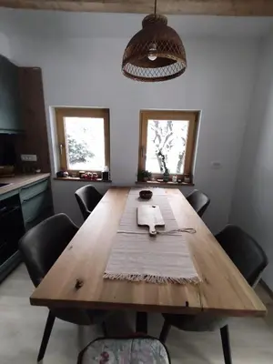 a large wooden table in a kitchen with chairs at Holiday Cabin near Ljubljana - Hawknest