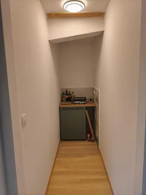 a hallway leading into a room with a counter and a table at Holiday Cabin near Ljubljana - Hawknest
