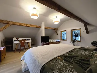 an attic bedroom with a bed and a desk at Holiday Cabin near Ljubljana - Hawknest