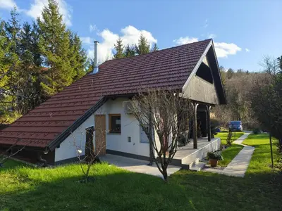 a small white house with a brown roof at Holiday Cabin near Ljubljana - Hawknest