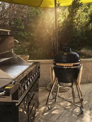 a grill sitting on a patio under an umbrella at Holiday Cabin near Ljubljana - Hawknest