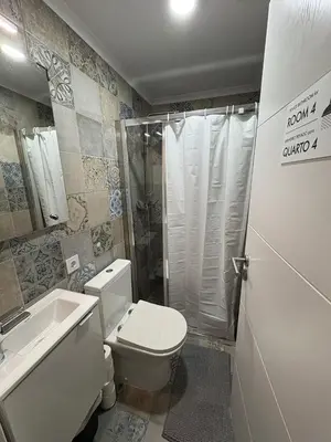 a bathroom with a toilet and a shower and a sink at Hotel Europe in Ljubljana