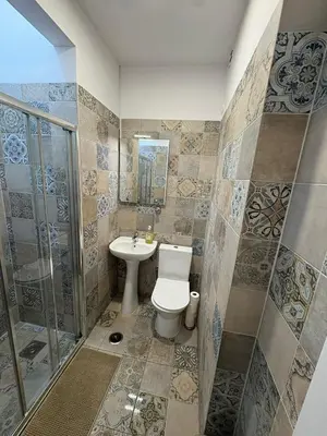 a bathroom with a toilet and a sink and a shower at Hotel Europe in Ljubljana
