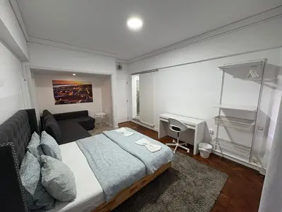 a bedroom with a large bed and a desk at Hotel Europe in Ljubljana