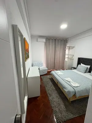 a bedroom with a bed and a chair in it at Hotel Europe in Ljubljana