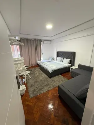 a living room with two beds and a couch at Hotel Europe in Ljubljana