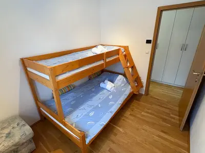 a bunk bed in a room with a mirror at Apartment Barbara with sauna in Gozd Martuljek