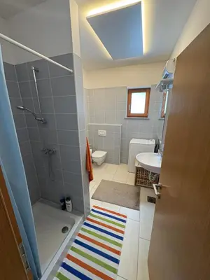 a bathroom with a shower and a sink at Apartment Barbara with sauna in Gozd Martuljek