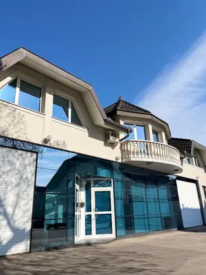 a building with a large glass door and a balcony at Linden Tree in Rove