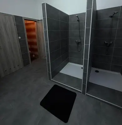 a bathroom with a shower with a glass wall at Linden Tree in Rove