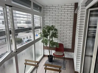 a balcony with a chair and a potted plant at Mary's flat in Ljubljana