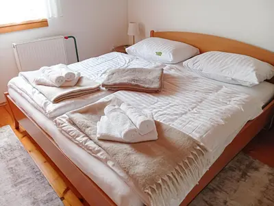 a bed with two towels and two pillows on it at Vineyard cottage Tilka in Novo Mesto