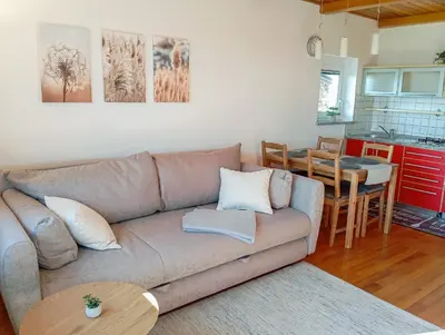 a living room with a couch and a table at Vineyard cottage Tilka in Novo Mesto