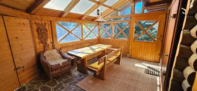 a room with a table and a chair in a cabin at Holiday cottage Pod Smreko in Cerklje na Gorenjskem