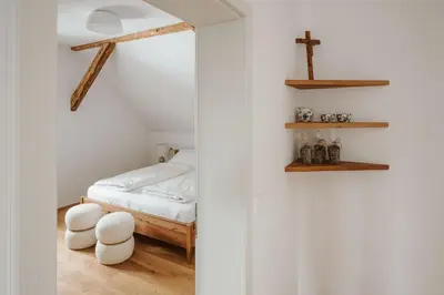 a bedroom with a bed and a cross on the wall at Apartmaji Matec in Fala