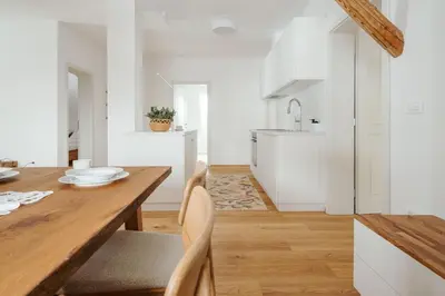 a kitchen and dining room with a wooden table at Apartmaji Matec in Fala