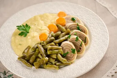 a plate of food with mushrooms and vegetables on a table at Farm Stay Gradišnik Peaceful Countryside with Homemade Breakfast in Prevalje
